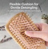 A hand holds a flexible wooden hair detangling brush with natural bamboo-like bristles. White text at the top reads 'Flexible Cushion for Gentle Detangling' with smaller descriptive copy below.