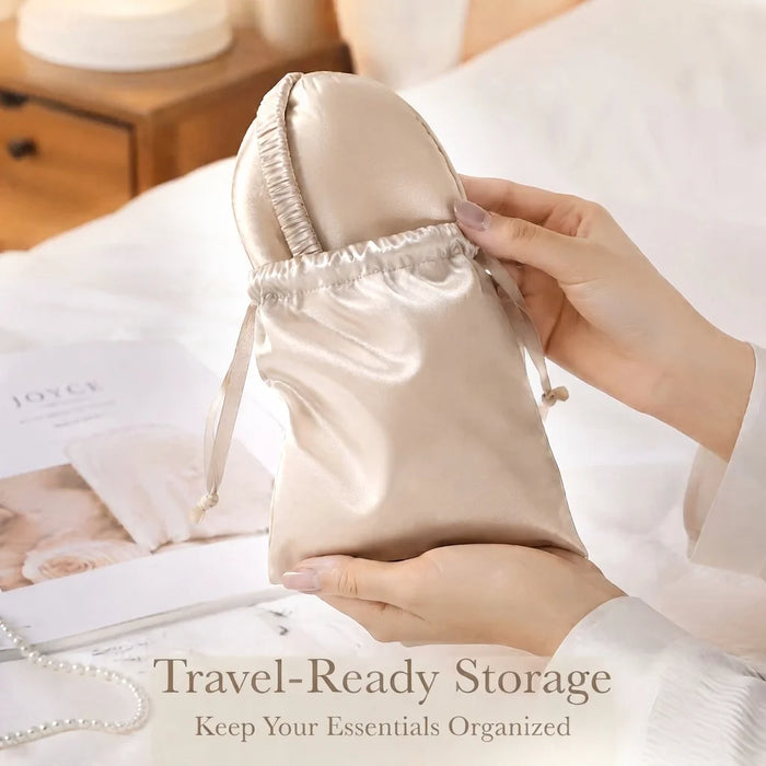 A satin drawstring storage pouch in a champagne beige color, held by hands in a bedroom setting. The pouch is shown as part of a travel-ready storage concept, with text overlay at the bottom reading 'Travel-Ready Storage Keep Your Essentials Organized'.