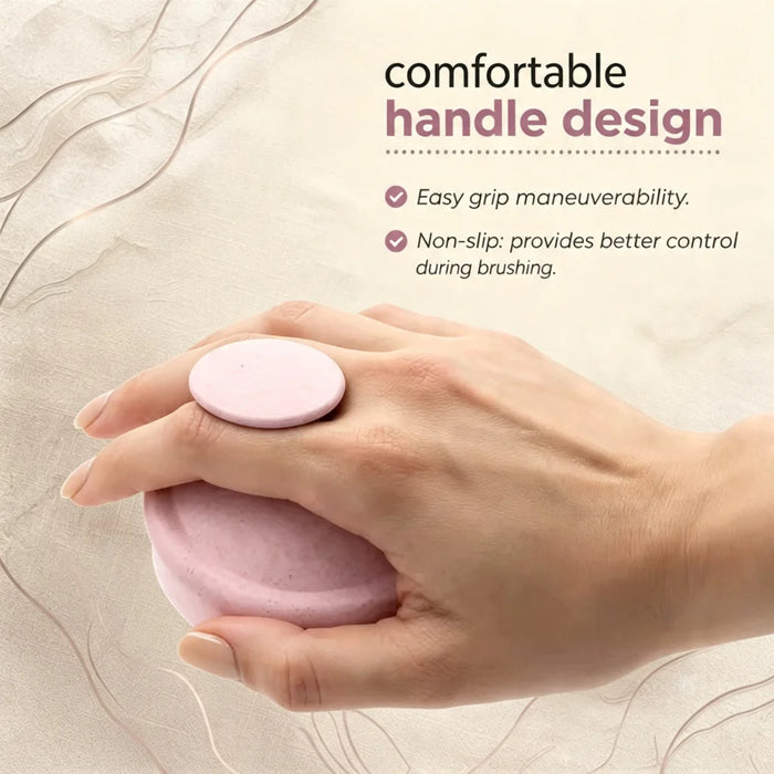 A hand holding a pink hair-brush attachment with a round finger rest, shown against a soft beige textured background with marketing text about comfortable handle design.