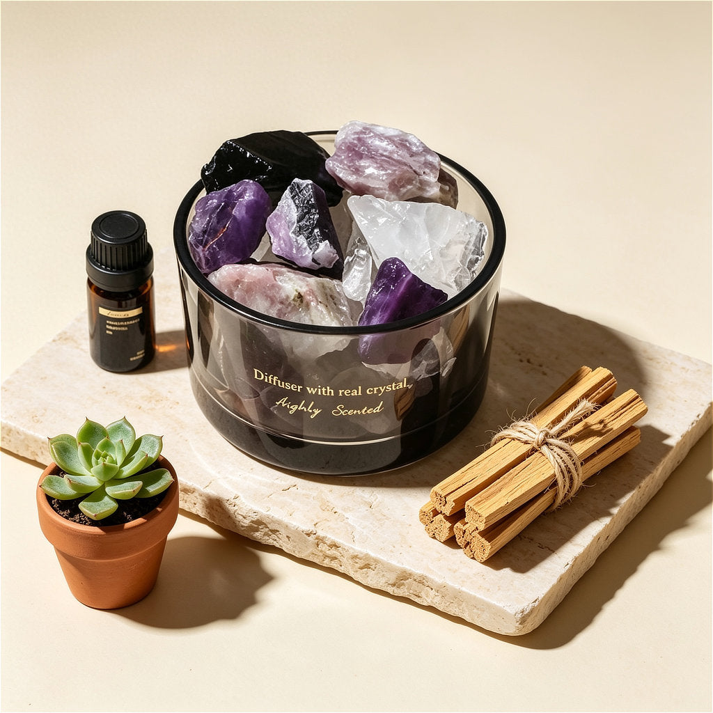 The ZenPulse Luminous Crystal Diffuser Lavender variant, featuring a dark glass bowl filled with raw Amethyst and clear quartz crystals. The set is displayed on a stone slab next to a small succulent, a bottle of essential oil, and a bundle of Palo Santo sticks, creating a serene wellness atmosphere.